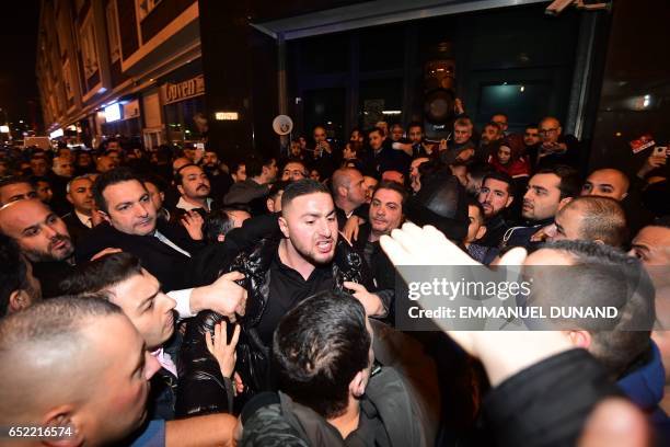 Turkish residents of the Netherlands gather for a protest outside Turkey's consulate in Rotterdam on March 11, 2017. Protests erupted in the Dutch...