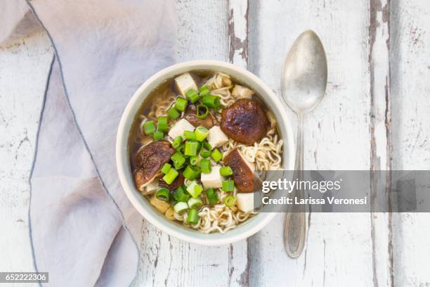 bowl of miso ramen soup with organic tofu, shitake mushrooms and spring onions on wood - miso stock-fotos und bilder