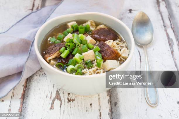 bowl of miso ramen soup with organic tofu, shitake mushrooms and spring onions on wood - miso stock-fotos und bilder