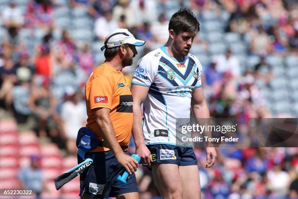 Joe Greenwood of the Titans leaves the ground after getting injured during the round two NRL match between the Newcastle Knights and the Gold Coast...