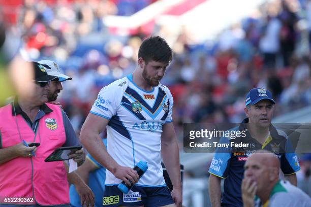 Joe Greenwood of the Titans leaves the ground after getting injured during the round two NRL match between the Newcastle Knights and the Gold Coast...