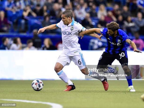 March 11: Osvaldo Alonso of the Seattle Sounders tries to get the ball past Hernan Bernardello of the Montreal Impact during the MLS game at Olympic...