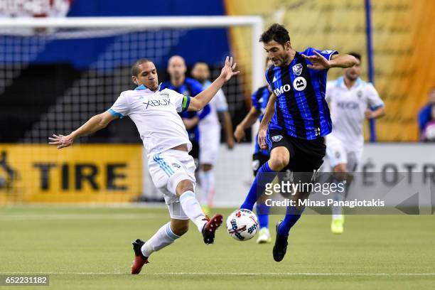 March 11: Ignacio Piatti of the Montreal Impact tries to kick the ball past Osvaldo Alonso of the Seattle Sounders during the MLS game at Olympic...
