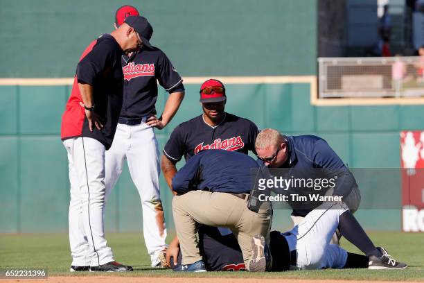 Terry Francona of the Cleveland Indians watches as medical staff attend to Guillermo Quiroz in the ninth inning against the Kansas City Royals during...