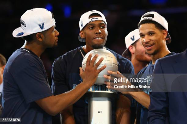 Josh Hart, Kris Jenkins and Darryl Reynolds of the Villanova Wildcats celebrate after defeating the Creighton Bluejays to win the Big East Basketball...