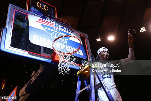 Mikal Bridges of the Villanova Wildcats cuts a piece of the net after defeating the Creighton Bluejays to win the Big East Basketball Tournament -...