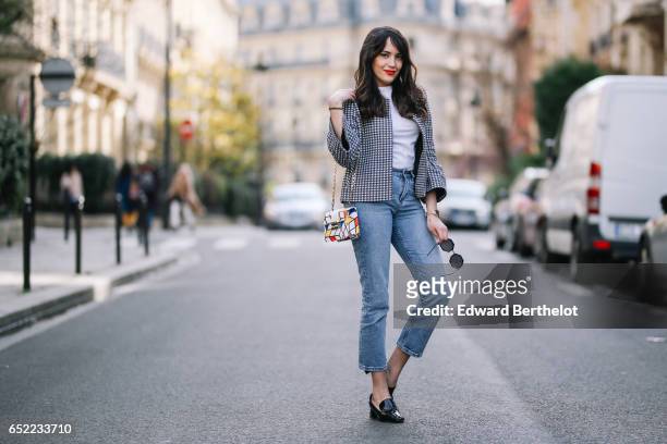 Sarah Benziane, fashion blogger, wears a Zara tweed checked jacket, a Zara white t-shirt, an Atelier Caesars multicolor bag, Newlook cropped blue...