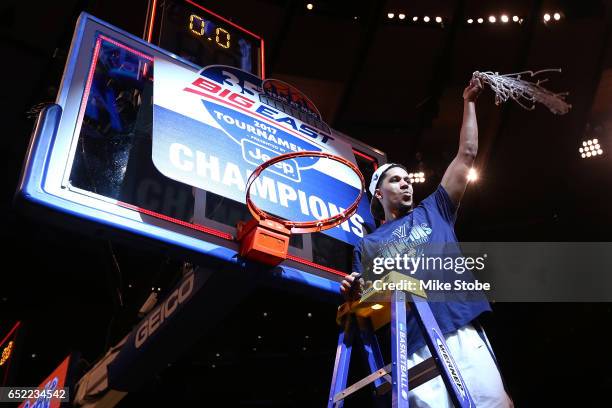 Josh Hart of the Villanova Wildcats cuts the net after defeating the Creighton Bluejays to win the Big East Basketball Tournament - Championship Game...