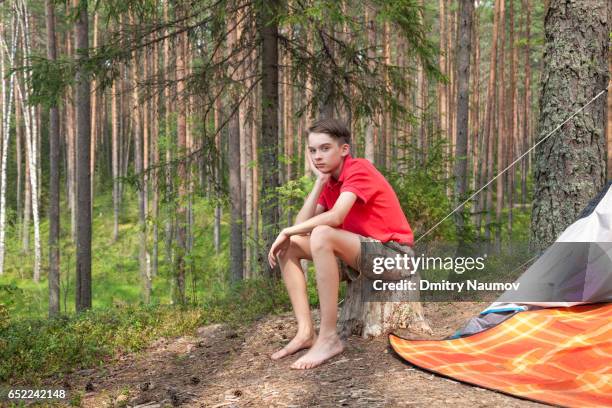 bored teen boy in a summer forest - teen boy barefoot stock pictures, royalty-free photos & images