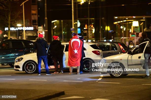 Turkish residents of the Netherlands gather for a protest outside Turkey's consulate in Rotterdam on March 11, 2017. Protests erupted in the Dutch...