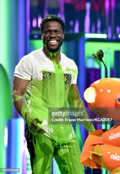 Actor Kevin Hart gets slimed onstage at Nickelodeon's 2017 Kids' Choice Awards at USC Galen Center on March 11, 2017 in Los Angeles, California.