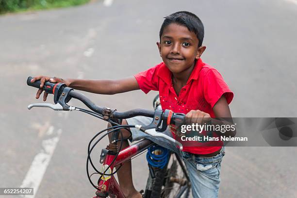 confident boy sitting on bicycle - tee srilanka stock pictures, royalty-free photos & images