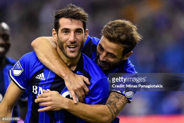 March 11: Ignacio Piatti of the Montreal Impact celebrates his goal as teammate Hernan Bernardello gives him a hug during the MLS game at Olympic...