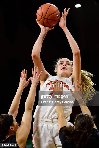 Bella Alarie of the Princeton Tigers shoots over Kelsey Bogdan and Katie Benzan of the Harvard Crimson during the fourth quarter of an Ivy League...