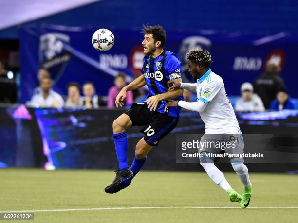 March 11: Ignacio Piatti of the Montreal Impact jumps in the air for the ball near Oniel Fisher of the Seattle Sounders during the MLS game at...