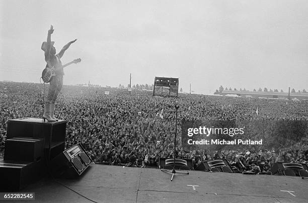 Guitarist Dave Hill performing with British rock group Slade, at the Monsters of Rock festival at Donington Park, Leicestershire, 22nd August 1981.