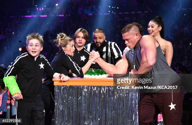 The cast of Nicky, Ricky, Dicky & Dawn armwrestle with host John Cena onstage with Dj Khaled at Nickelodeon's 2017 Kids' Choice Awards at USC Galen...