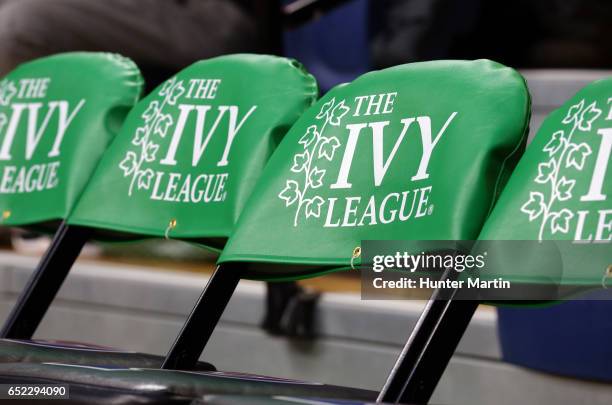 The Ivy League logo is displayed on chairs on the players bench during a game between the Princeton Tigers and the Pennsylvania Quakers at The...