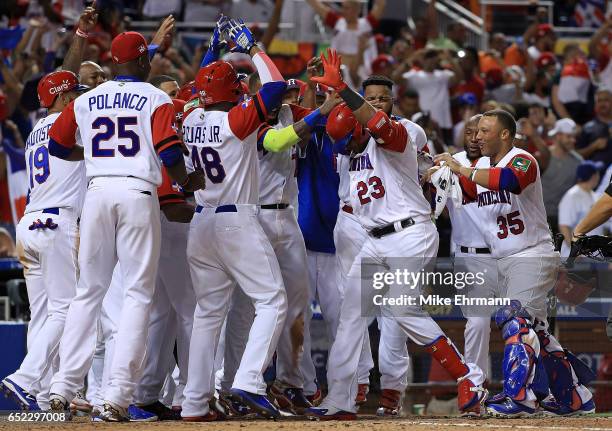 Nelson Cruz of the Dominican Republic is congratulated after hitting a three run home run during the eighth inning of a Pool C game of the 2017 World...