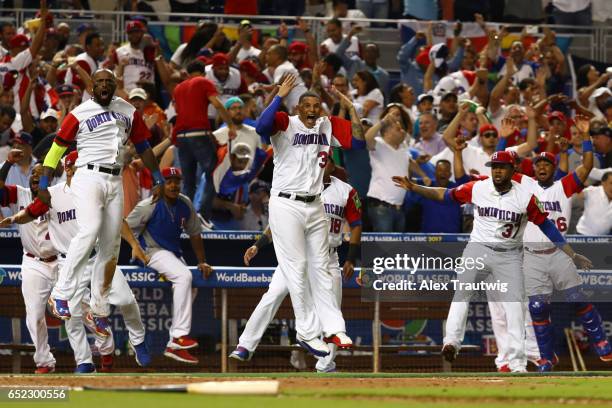 Members of Team Dominican Republic react to a Nelson Cruz three-run home run in the eighth inning during Game 4 Pool C of the 2017 World Baseball...