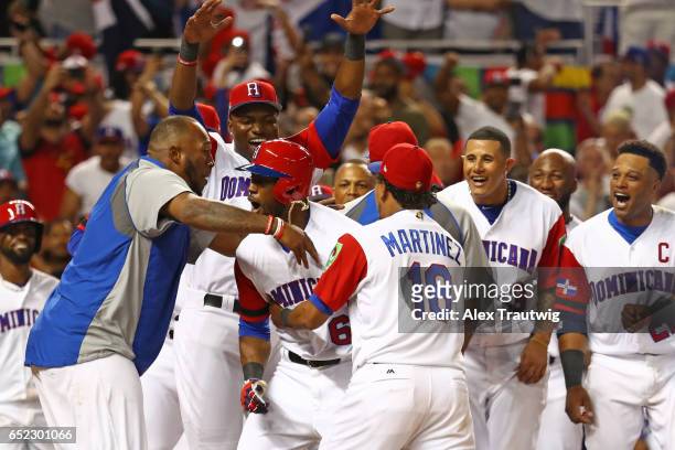 Starling Marte of Team Dominican Republic is greeted at home plate after hitting a solo home run in the during Game 4 Pool C of the 2017 World...