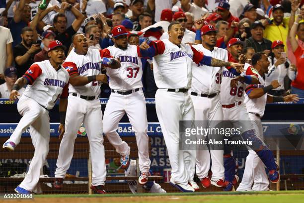 Members of Team Dominican Republic react to a Starling Marte solo home run in the eighth inning during Game 4 Pool C of the 2017 World Baseball...