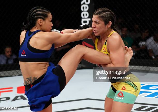 Bethe Correia of Brazil punches Marion Reneau in their women's bantamweight bout during the UFC Fight Night event at CFO - Centro de Formaco...