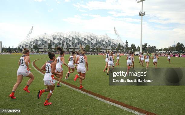 The Giants run onto the field during the round six AFL Women's match between the Collingwood Magpies and the Greater Western Sydney Giants at Olympic...