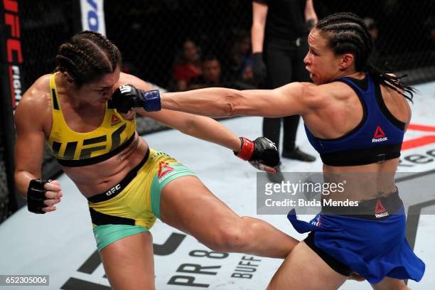 Marion Reneau punches Bethe Correia of Brazil in their women's bantamweight bout during the UFC Fight Night event at CFO - Centro de Formaco...