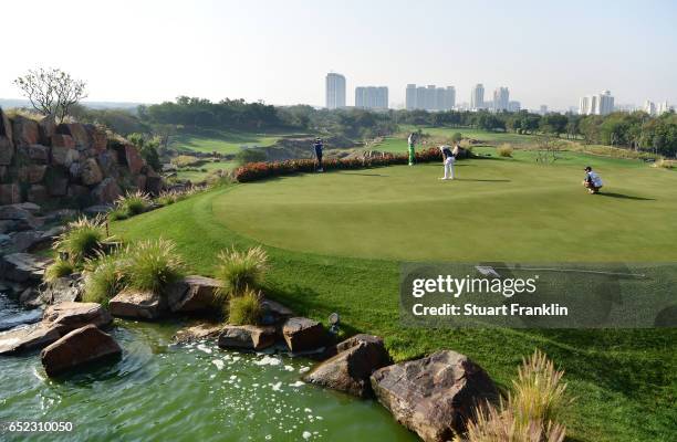 David Horsey of England putts on the 17th hole during the continuation of the delayed third round the Hero Indian Open at Dlf Golf and Country Club...