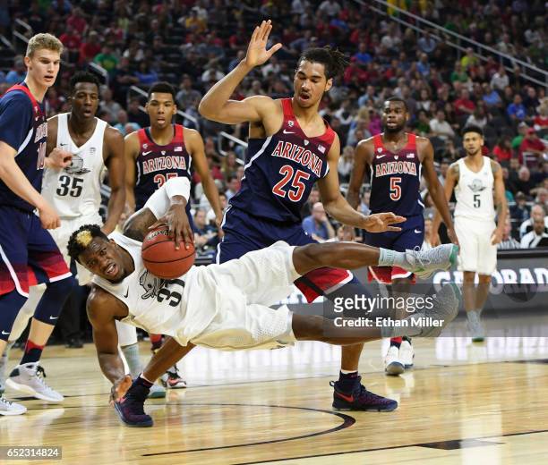 Keanu Pinder of the Arizona Wildcats fouls Dylan Ennis of the Oregon Ducks during the championship game of the Pac-12 Basketball Tournament at...