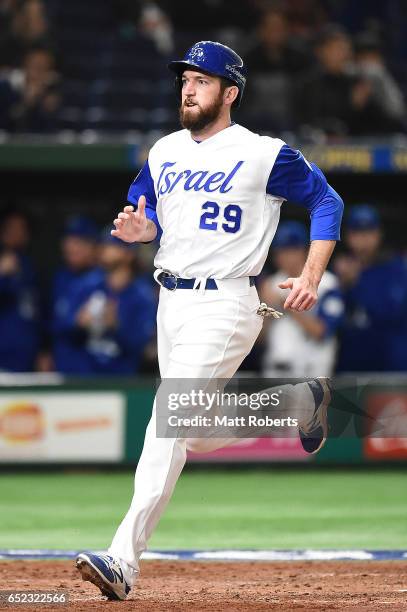 Ike Davis of Israel comes back home as Ryan Lavarnway of Israel hits a RBI double grounder to left field in the fourth inning during the World...