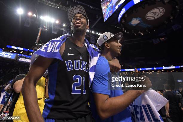 Amile Jefferson and Matt Jones of the Duke Blue Devils celebrate following their 75-69 victory against the Notre Dame Fighting Irish during the ACC...