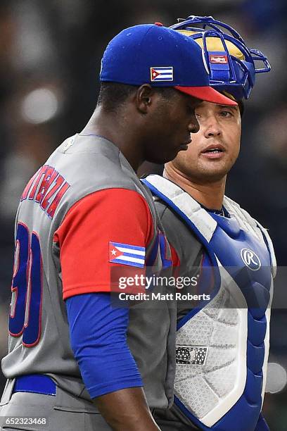 Catcher Frank Morejon reacts with Noelvis Entenza of Cuba after catching a pop-out by Blake Gailen of Israel in the fourth inning during the World...