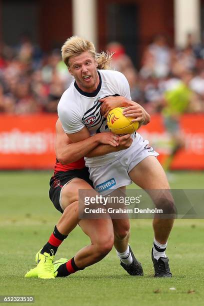 George Horlin-Smith of the Cats is tackled during the JLT Community Series AFL match between the Geelong Cats and the Essendon Bombers at Queen...