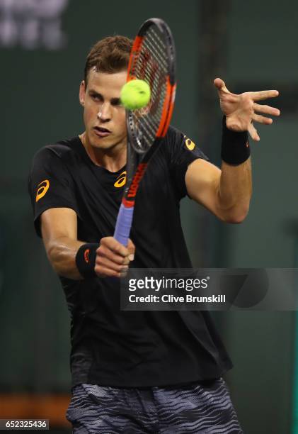 Vasek Pospisil of Canada plays a backhand during his straight sets victory against Andy Murray of Great Britain in their second round match during...