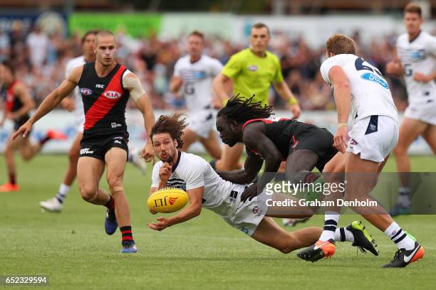 Josh Cowan of the Cats handballs during the JLT Community Series AFL match between the Geelong Cats and the Essendon Bombers at Queen Elizabeth Oval...