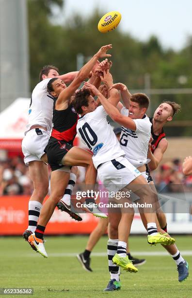Players contest the ball during the JLT Community Series AFL match between the Geelong Cats and the Essendon Bombers at Queen Elizabeth Oval on March...