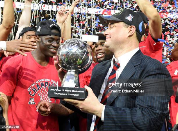 Rawle Alkins and head coach Sean Miller of the Arizona Wildcats celebrate with the trophy after defeating the Oregon Ducks 83-80 to win the...