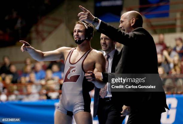 Dustin Weinmann of Wisconsin-La Crosse celebrates after beating Cross Cannone of Wartburg in the 141 weight class during NCAA Photos via Getty Images...