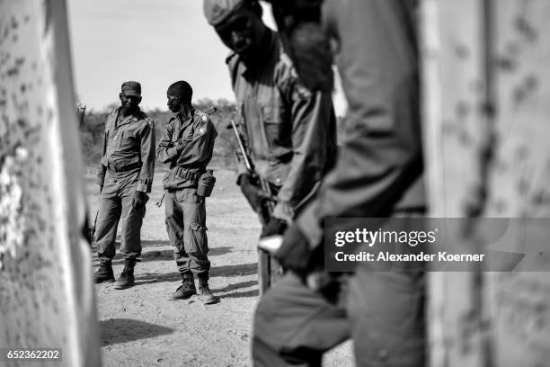 Soldiers of the Malian Armed Forces look at the results after shooting with live ammunition at the shooting range at a training base on March 09 2017...