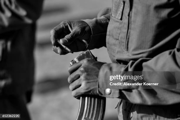 Soldier of the Malian Armed Forces loads his AK47 rifle before shooting with live ammunition at the shooting range at a training base on March 09...