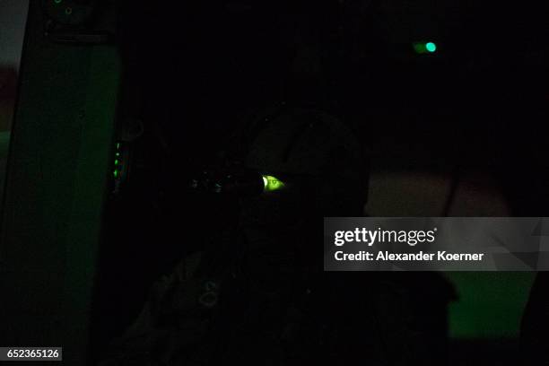 The board engineer of the NH90 Helicopter of the Bundeswehr, the German Armed Forces, observes the desert during a night training flight using night...