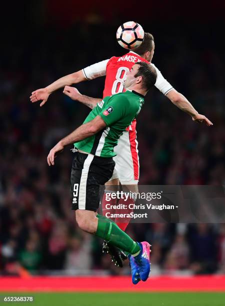 Lincoln City's Matt Rhead vies for possession with Arsenal's Aaron Ramsey during the Emirates FA Cup Quarter-Final match between Arsenal and Lincoln...