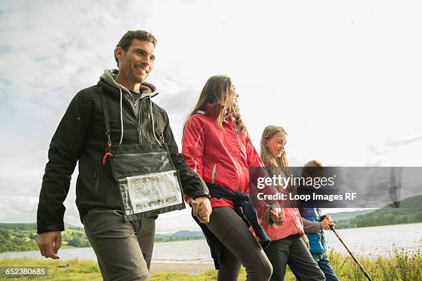 a family of five walking on the shore of bala lake in wales - north wales map stock pictures, royalty-free photos & images