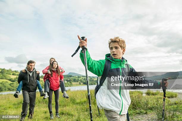 a family of five walking on the shore of bala lake in wales - north wales map stock pictures, royalty-free photos & images