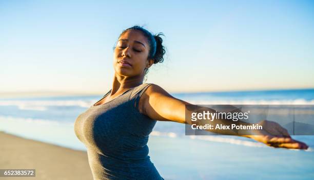 young tanned mixed-race girl practicing fitness on the beach - alex potemkin or krakozawr latino fitness stock pictures, royalty-free photos & images