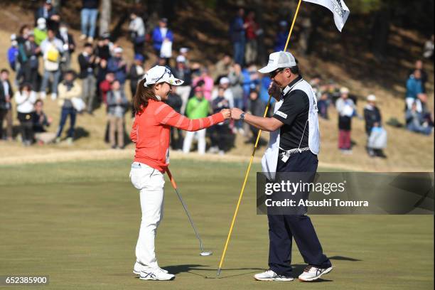 Riho Fujisaki of Japan celebrates after making her par putt on the 18th green during the final round of the Yokohama Tire PRGR Ladies Cup at the Tosa...