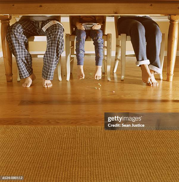 father and children at table - family feet stock-fotos und bilder