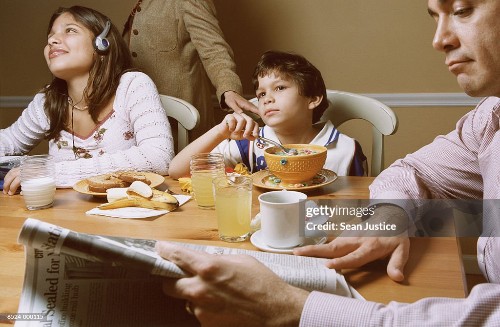 Family Sitting at Dining Table